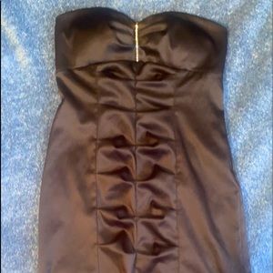 This is a strapless too gut black dress